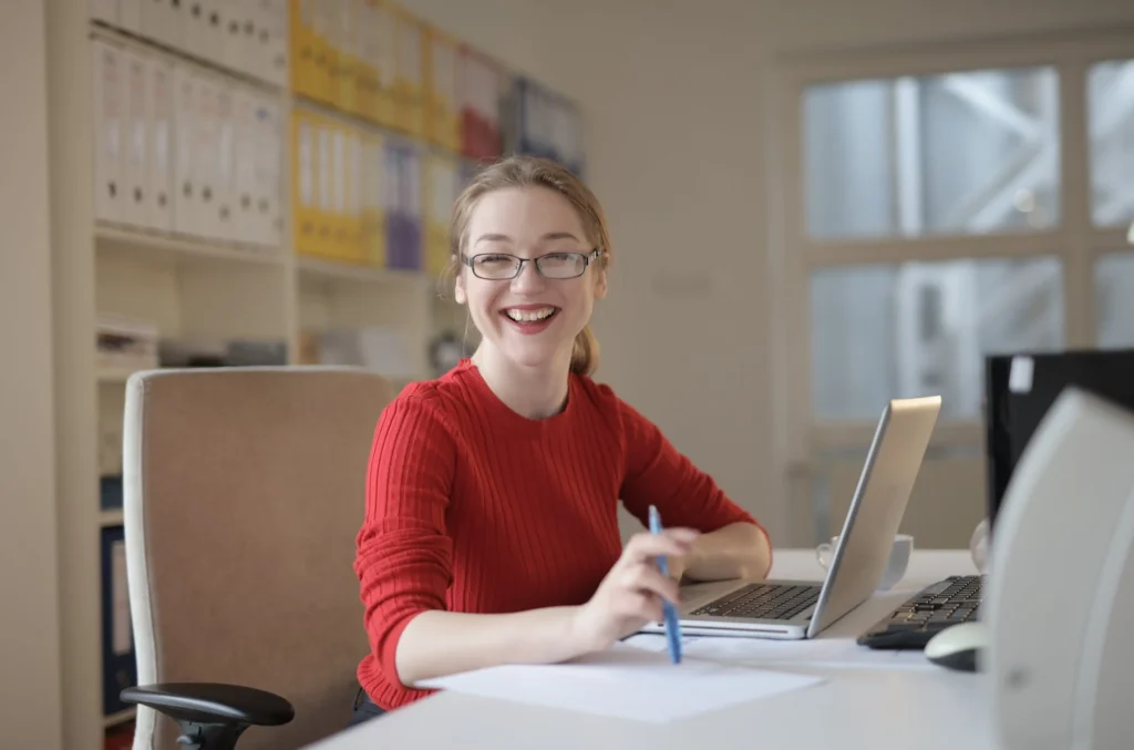 woman-smiles-at-desk